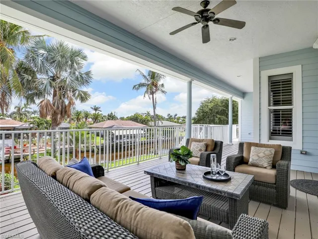 Wooden deck featuring ceiling fan and an outdoor living space
