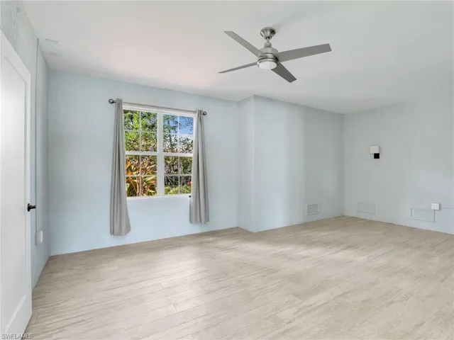 Empty room featuring ceiling fan and light hardwood / wood-style floors
