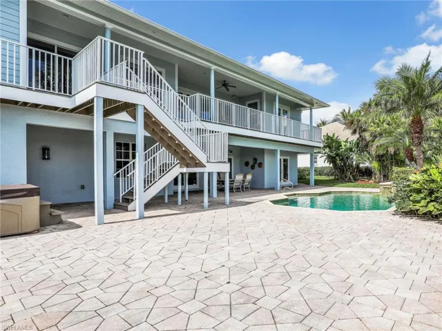 View of swimming pool featuring ceiling fan and a patio