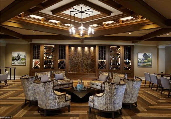 Expansive room featuring a coffered wood-beam ceiling with recessed lighting