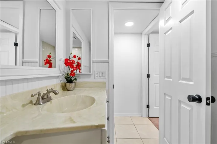 Bathroom featuring vanity, light tile patterned floors, and recessed lighting