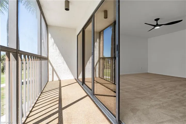 Balcony featuring a sunroom and ceiling fan