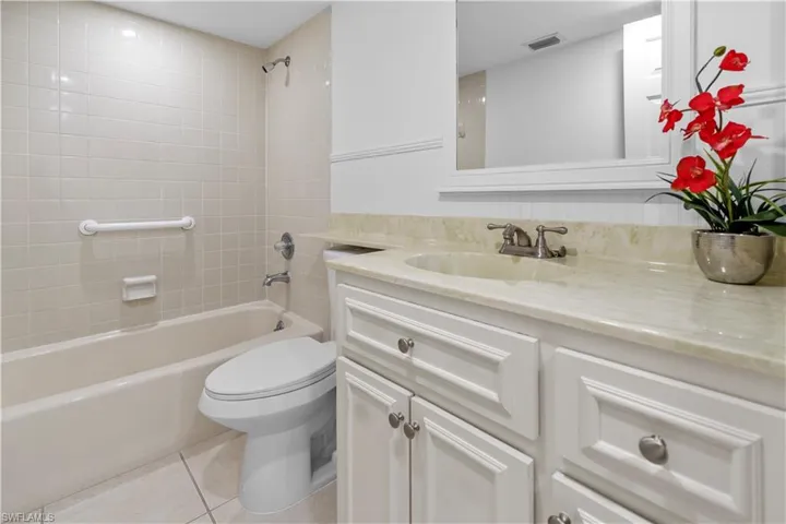 Full bathroom with vanity, light tile patterned flooring, and tub / shower combination