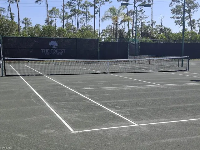 Tennis court with a dark green playing surface and white line markings