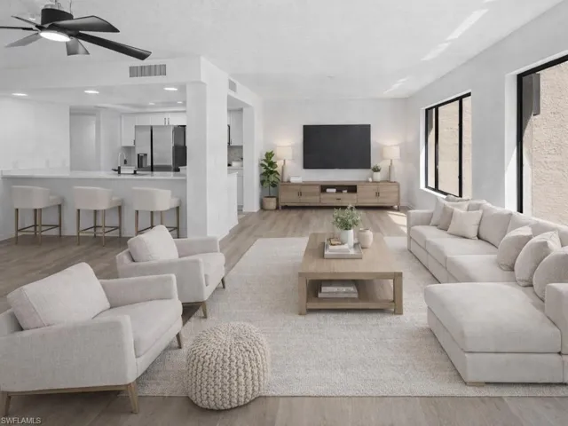 Living room featuring light wood-style flooring and a ceiling fan