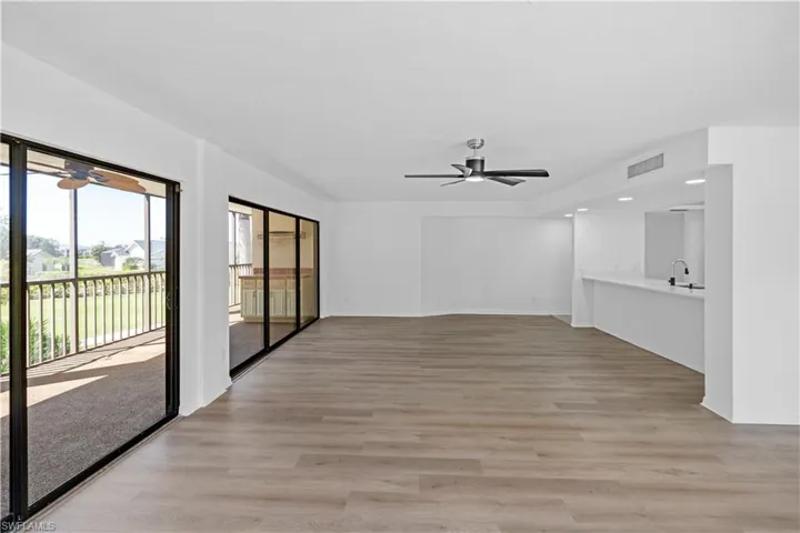 Unfurnished living room featuring a ceiling fan and light wood finished floors