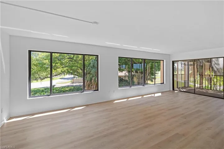 Spare room with light wood-style floors and plenty of natural light