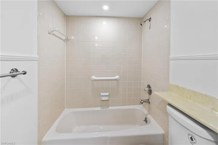 Bathroom featuring toilet and shower / washtub combination