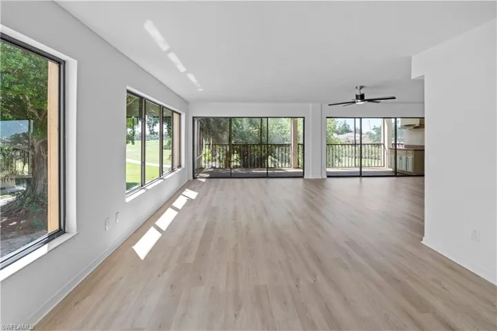 Empty room with light wood-style floors and a ceiling fan
