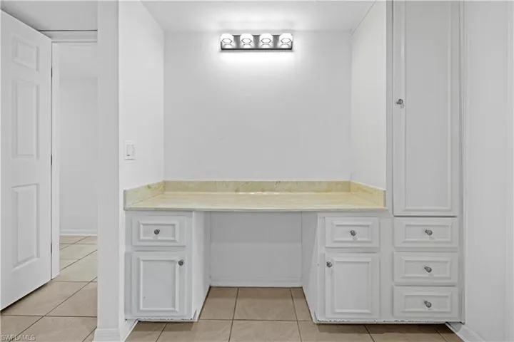 Bathroom featuring light tile patterned floors and vanity