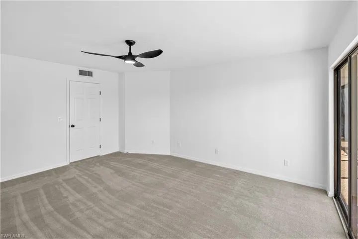 Unfurnished bedroom with a ceiling fan and carpet flooring