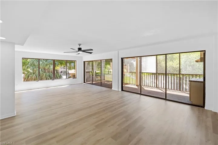 Unfurnished living room with a ceiling fan and light wood-style flooring