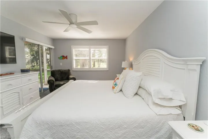 Bedroom with access to outside and a ceiling fan