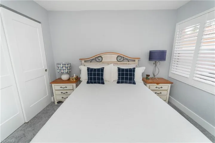 Bedroom featuring light colored carpet and a closet