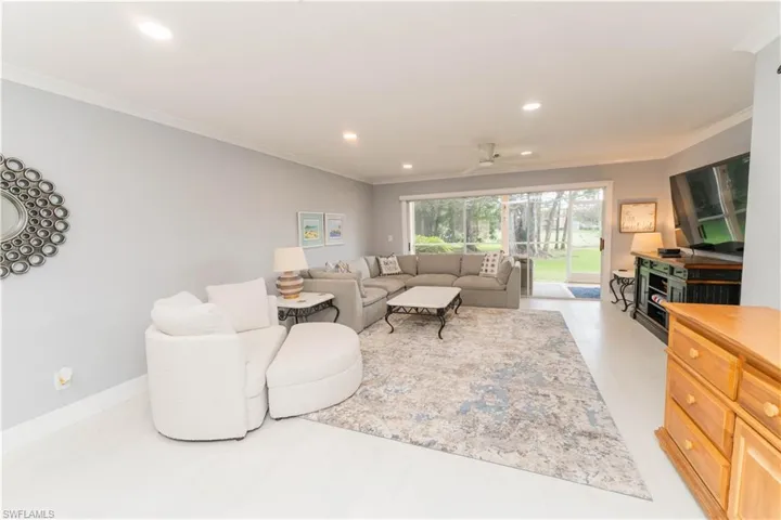 Living area featuring ornamental molding, recessed lighting, and a ceiling fan