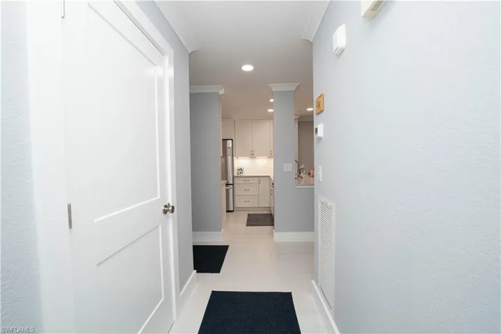 Hall featuring light tile patterned floors and recessed lighting