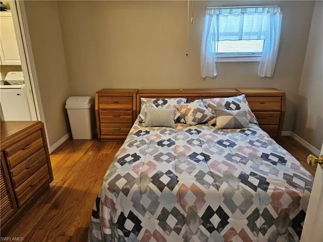 Bedroom with baseboards and wood finished floors