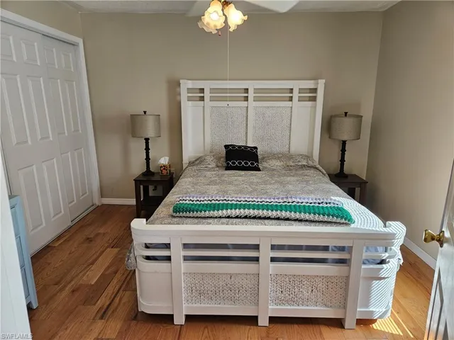 Bedroom featuring baseboards and wood finished floors
