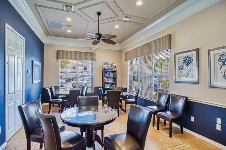 Office with coffered ceiling, recessed lighting, ceiling fan, ornamental molding, and a textured wall