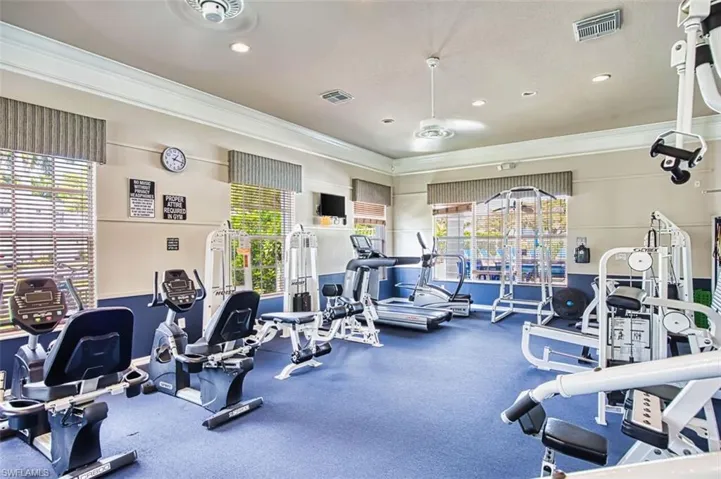 Exercise room featuring ornamental molding and recessed lighting