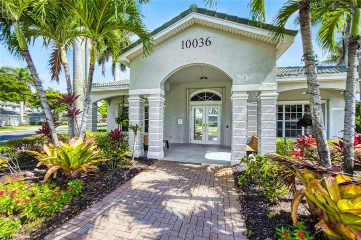 View of exterior entry featuring stucco siding, french doors, and a tiled roof