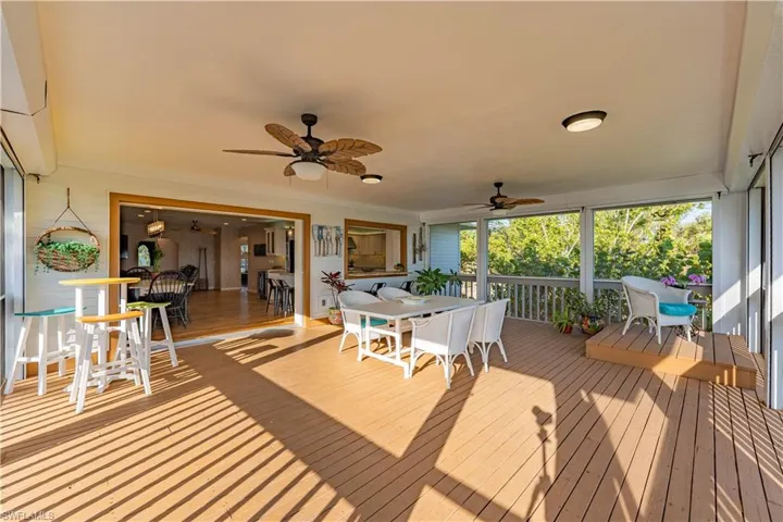 Deck with a ceiling fan and outdoor dining area