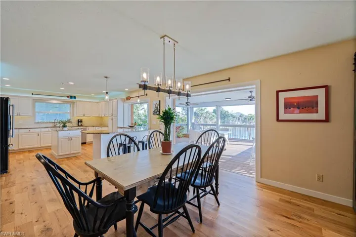 Dining area featuring a healthy amount of sunlight, light wood finished floors, and baseboards