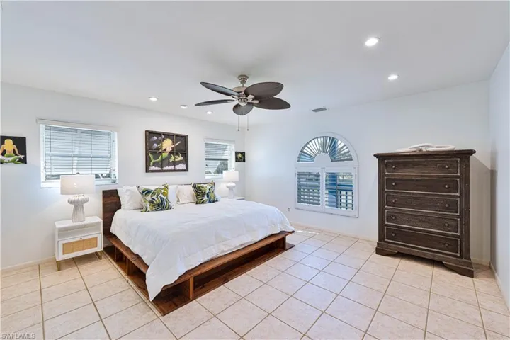 Bedroom featuring visible vents, recessed lighting, multiple windows, and light tile patterned floors