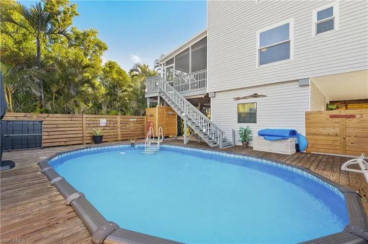 View of pool featuring a wooden deck