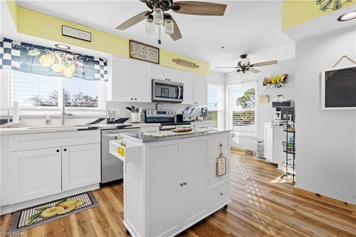 Kitchen island, sink in front of window