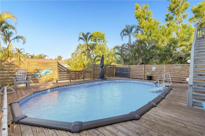 View of swimming pool with a wooden deck