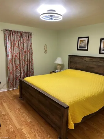 Bedroom with hardwood / wood-style flooring