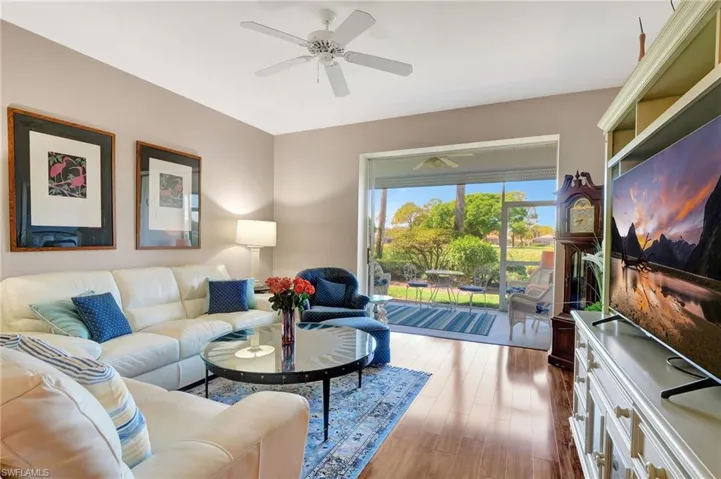Living area with ceiling fan and wood finished floors