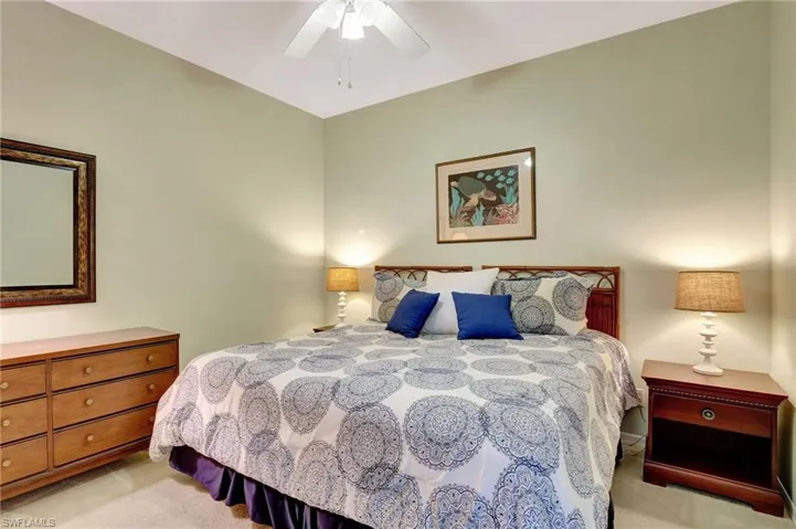 Bedroom with light colored carpet and ceiling fan