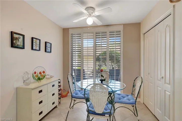 Dining room with ceiling fan and light tile patterned floors