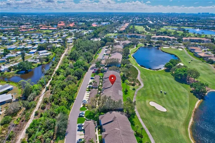 Aerial view of property and surrounding area with a large body of water and nearby suburban area