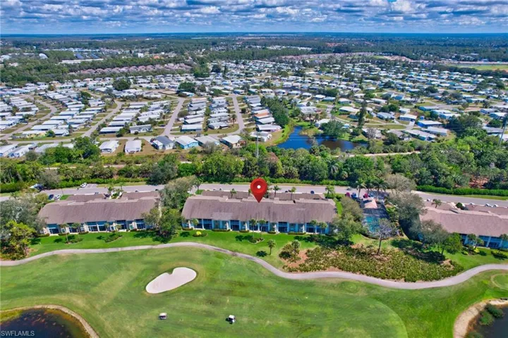 View of property location featuring a large body of water and nearby suburban area