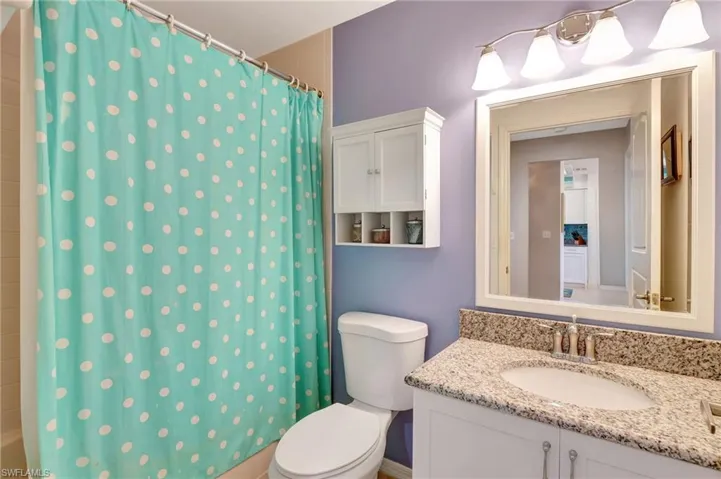 Full bathroom featuring vanity and shower / bathtub combination with curtain