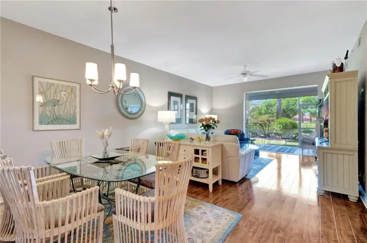 Dining room featuring wood finished floors, a ceiling fan, and hanging lights