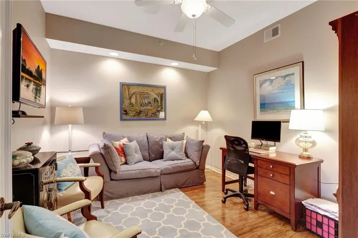 Home office featuring light wood finished floors, ceiling fan, and recessed lighting