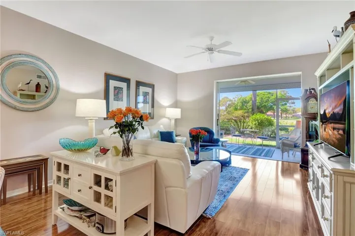 Living area with ceiling fan and light wood-type flooring