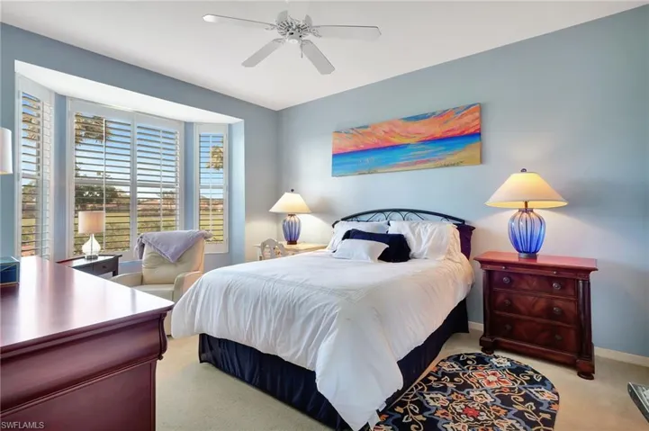 Bedroom featuring light carpet and a ceiling fan