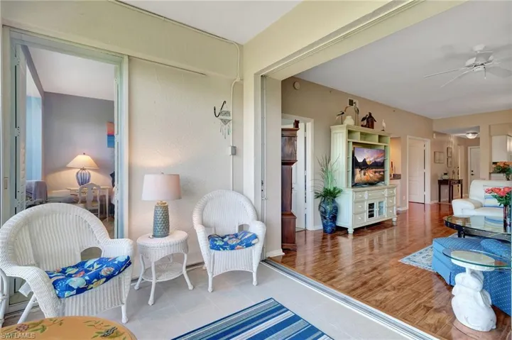 Living area featuring ceiling fan and tile patterned floors