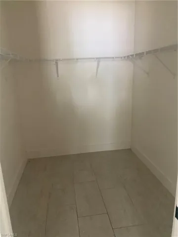 Walk in closet featuring tile patterned flooring