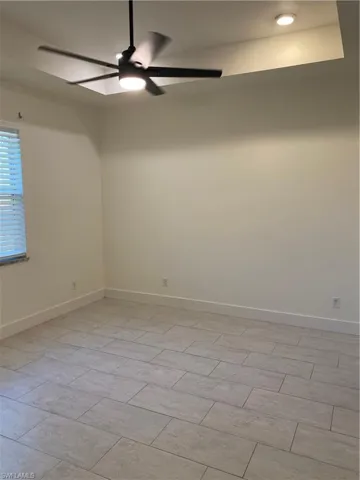 Empty room with ceiling fan and recessed lighting