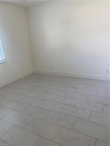 Empty room featuring baseboards