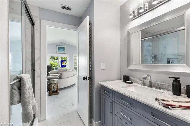 Guest bath is adjacent to Guest Bedroom just off of Living Room.  Quartz counter top vanity and shower.