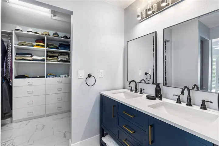 Owner's Suite showing double vanity and walk-in closet with built-ins.