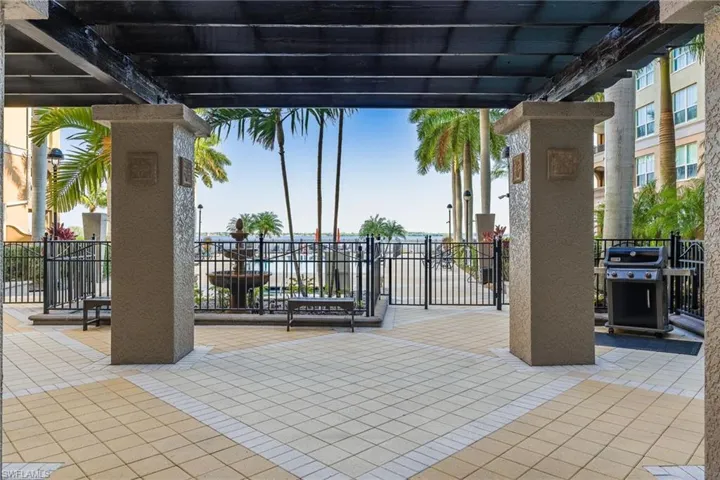 View of patio with a grill and a pergola