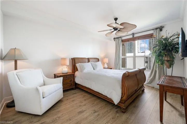 Bedroom featuring ornamental molding, hardwood / wood-style floors, and ceiling fan